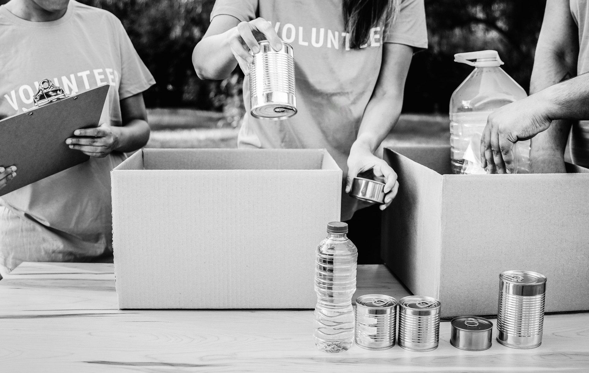 Charity food, Volunteer teamwork collecting donations to help people in need. Humanitarian aid, assistance and community support. Black and white editing