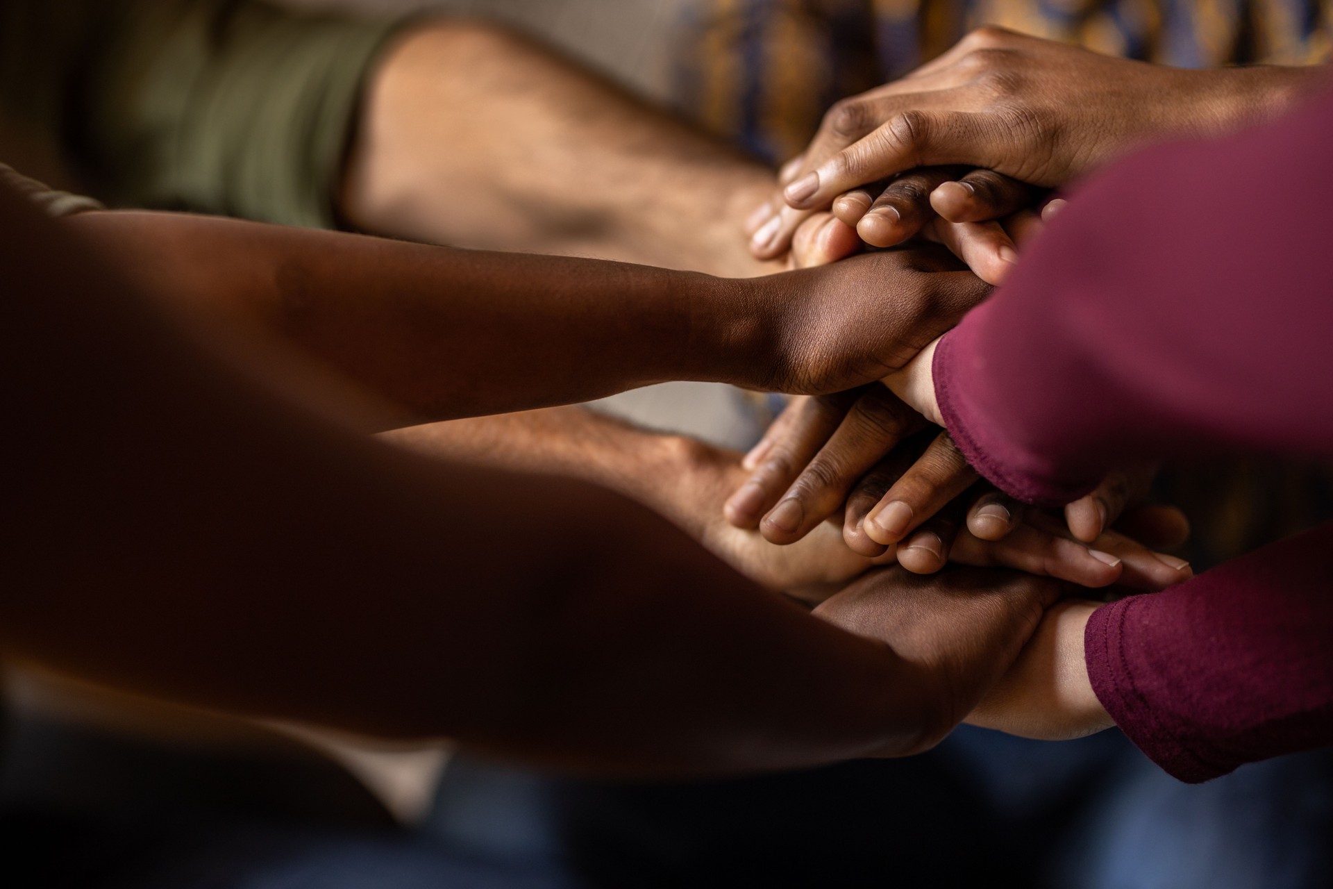 Diverse team of businesspeople with their hands in a huddle